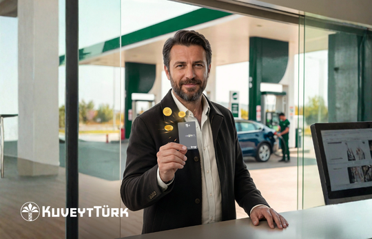 a man holding saglam business card in Fuel station