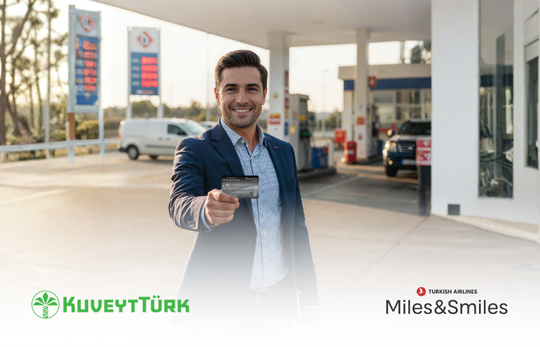 a man who is holding a kuveytturk credit card