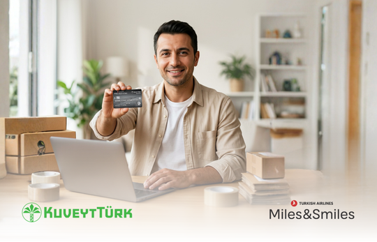 a man who is holding a kuveytturk credit card