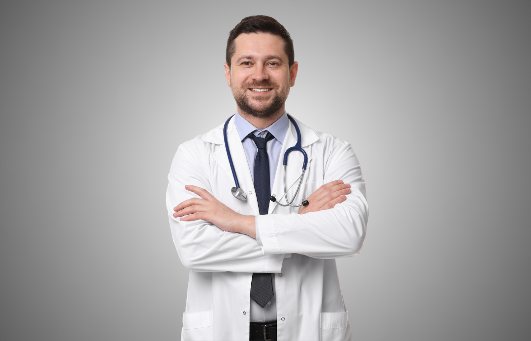 Önlüğü ve stetoskobu olan gülümseyen bir doktor
