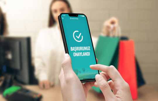 A phone showing approval for a consumer financing application during a shopping trip