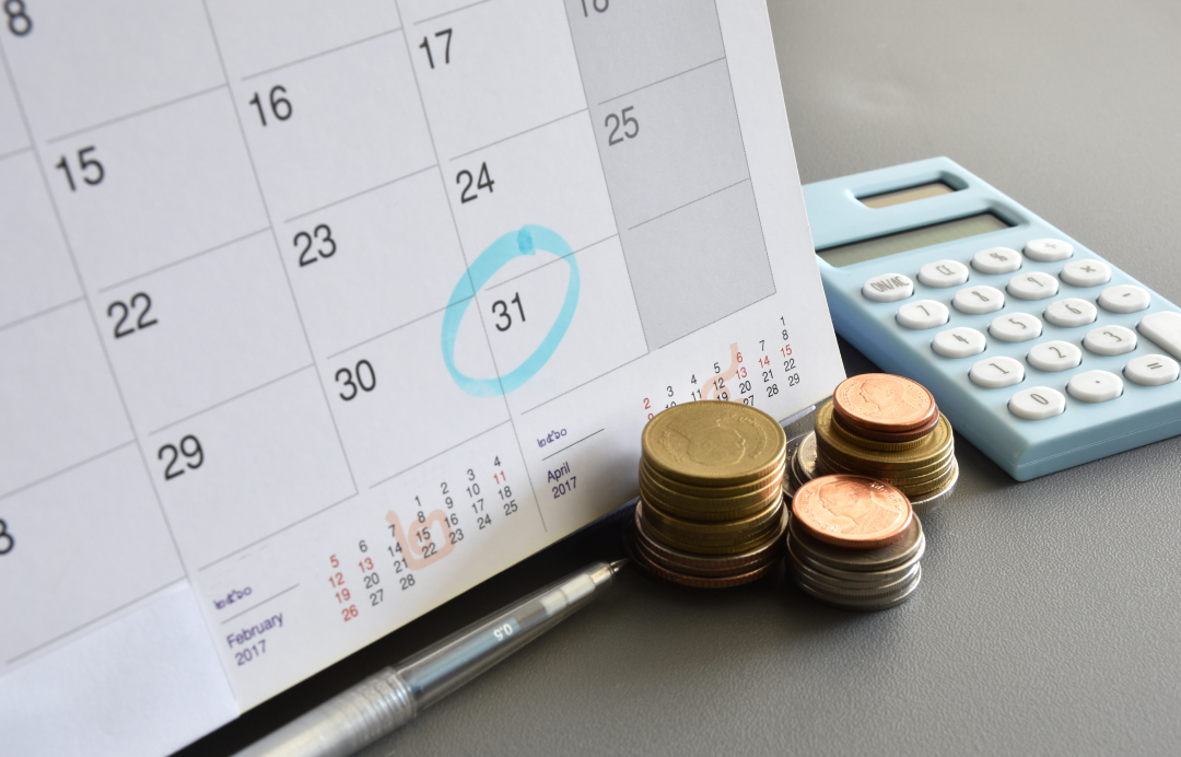 Marked calendar pen and calculator with coins