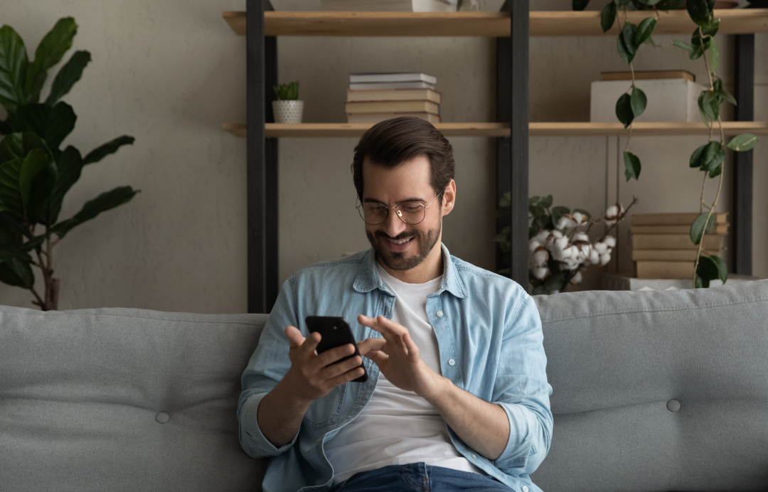 a man sitting on a phone in his hand