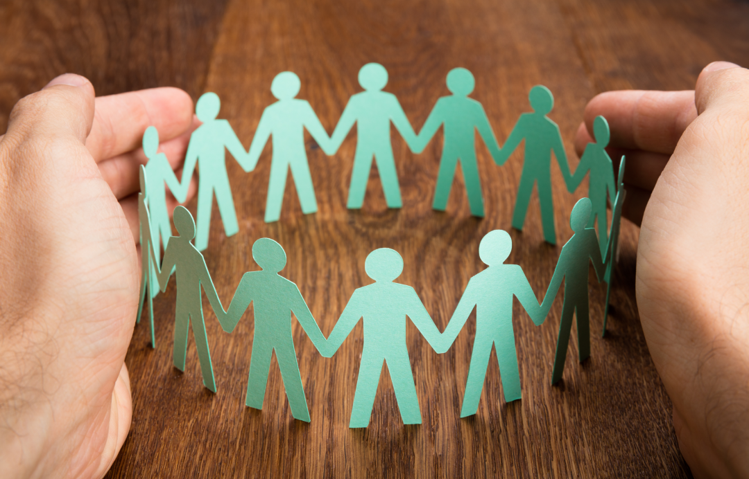 Group pension and security concept with human figures protected under insurance coverage
