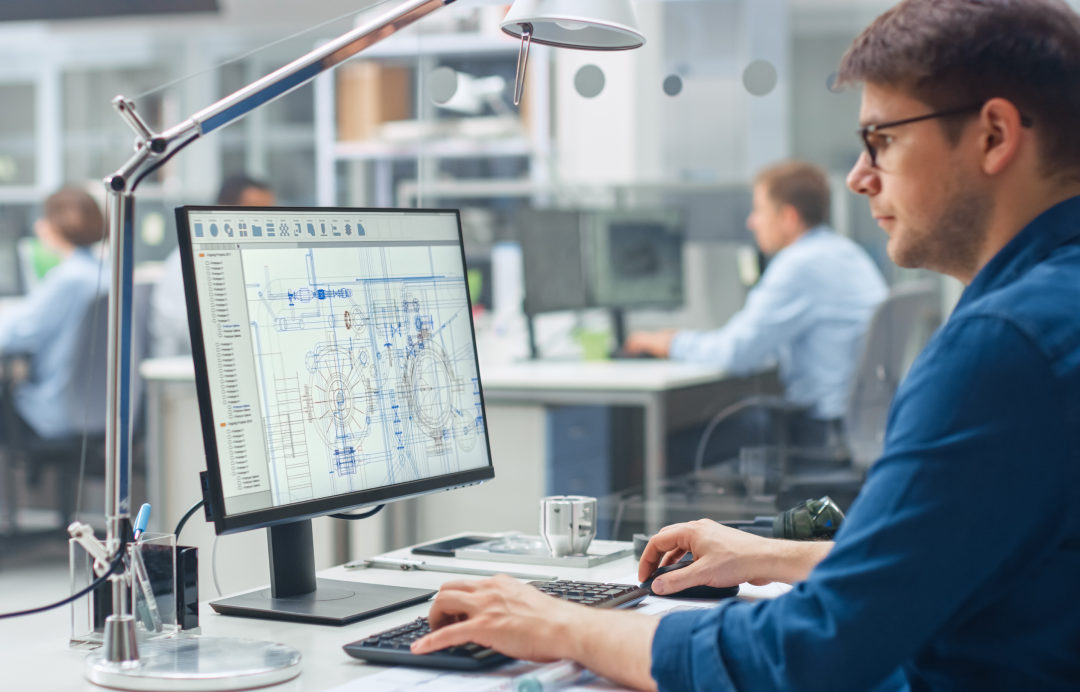 Engineer reviewing technical drawings on a computer screen
