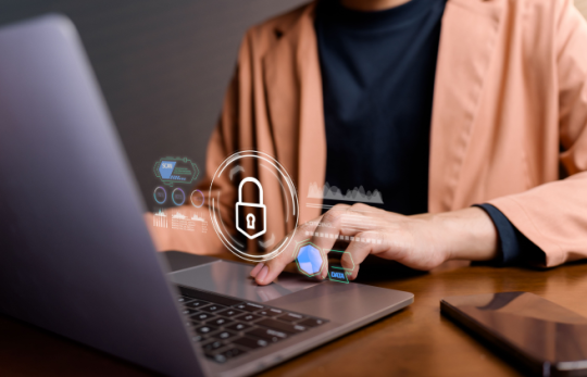 Person using laptop with digital lock security overlay