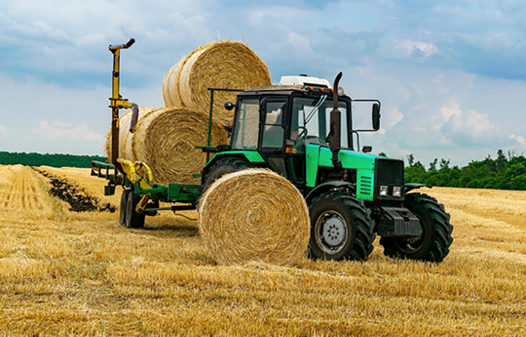 hay bales and tractor in the hay field