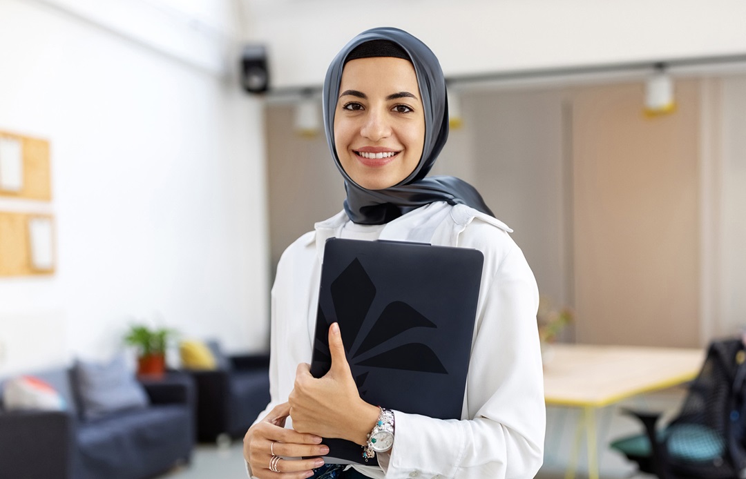 Smiling professional holding a folder in the workplace