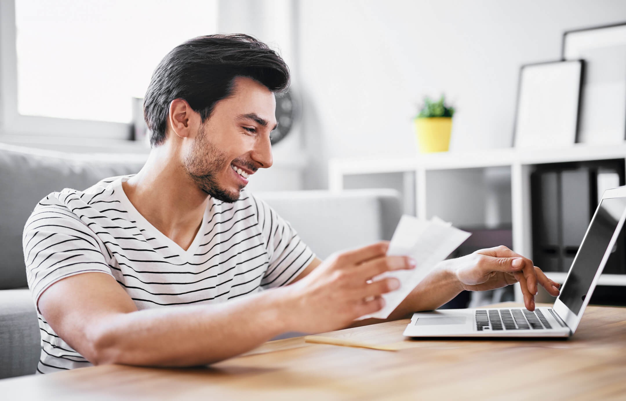 young person doing financial transactions at computer