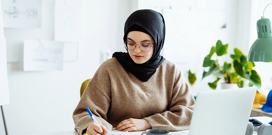 Bilgisayar başında not alan kadın