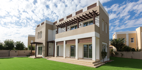 A two-story white villa with a large lawn