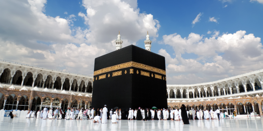 The Kaaba on a bright day with people performing the tawaf