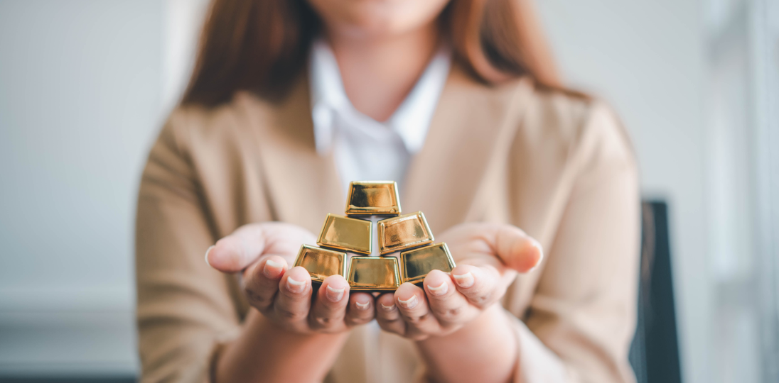 Woman holding a gold bar