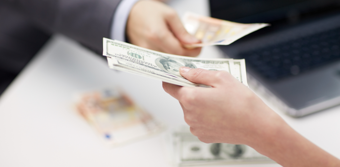 Hands involved in currency exchange