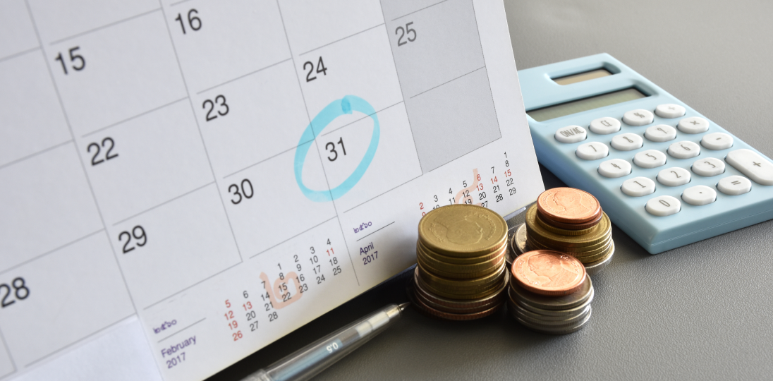 Marked calendar pen and calculator with coins