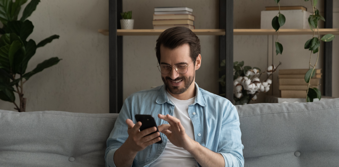 a man sitting on a phone in his hand