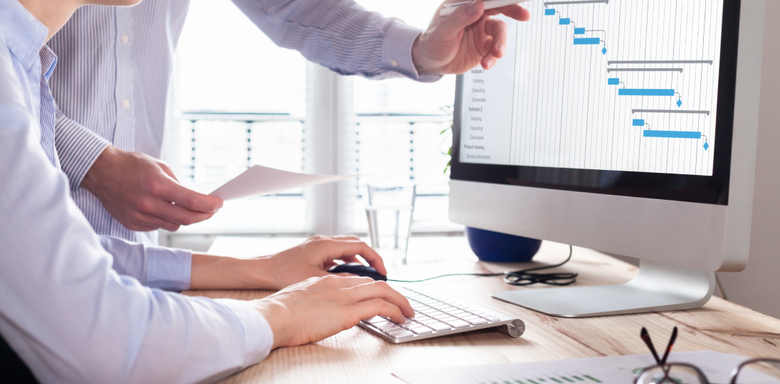 office workers reviewing reports on computers