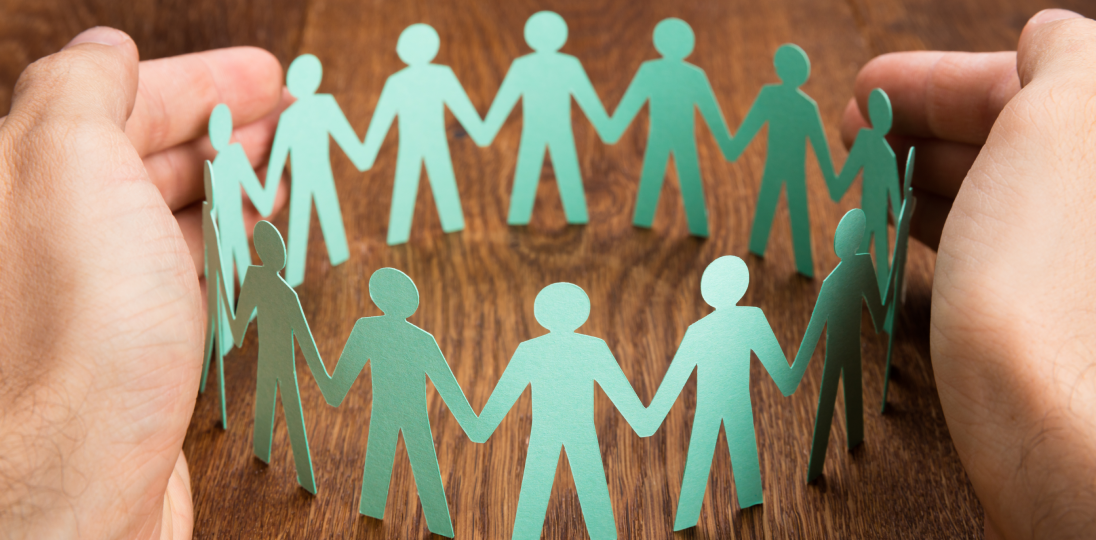 Group pension and security concept with human figures protected under insurance coverage
