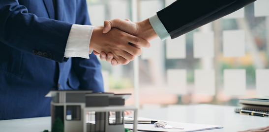 Professionals shaking hands to finalize an agreement in the office