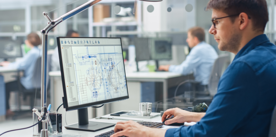 Engineer reviewing technical drawings on a computer screen