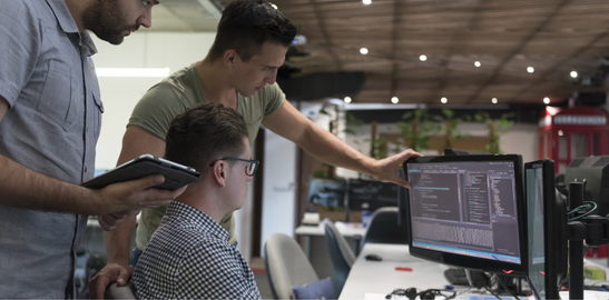 Software develops collaborating at computer workstations