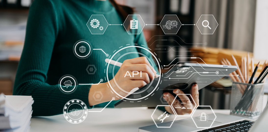 Person using a tablet with API integration interface graphics