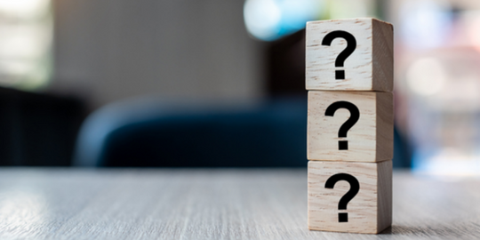 Three wooden blocks symbolizing inquiry and support